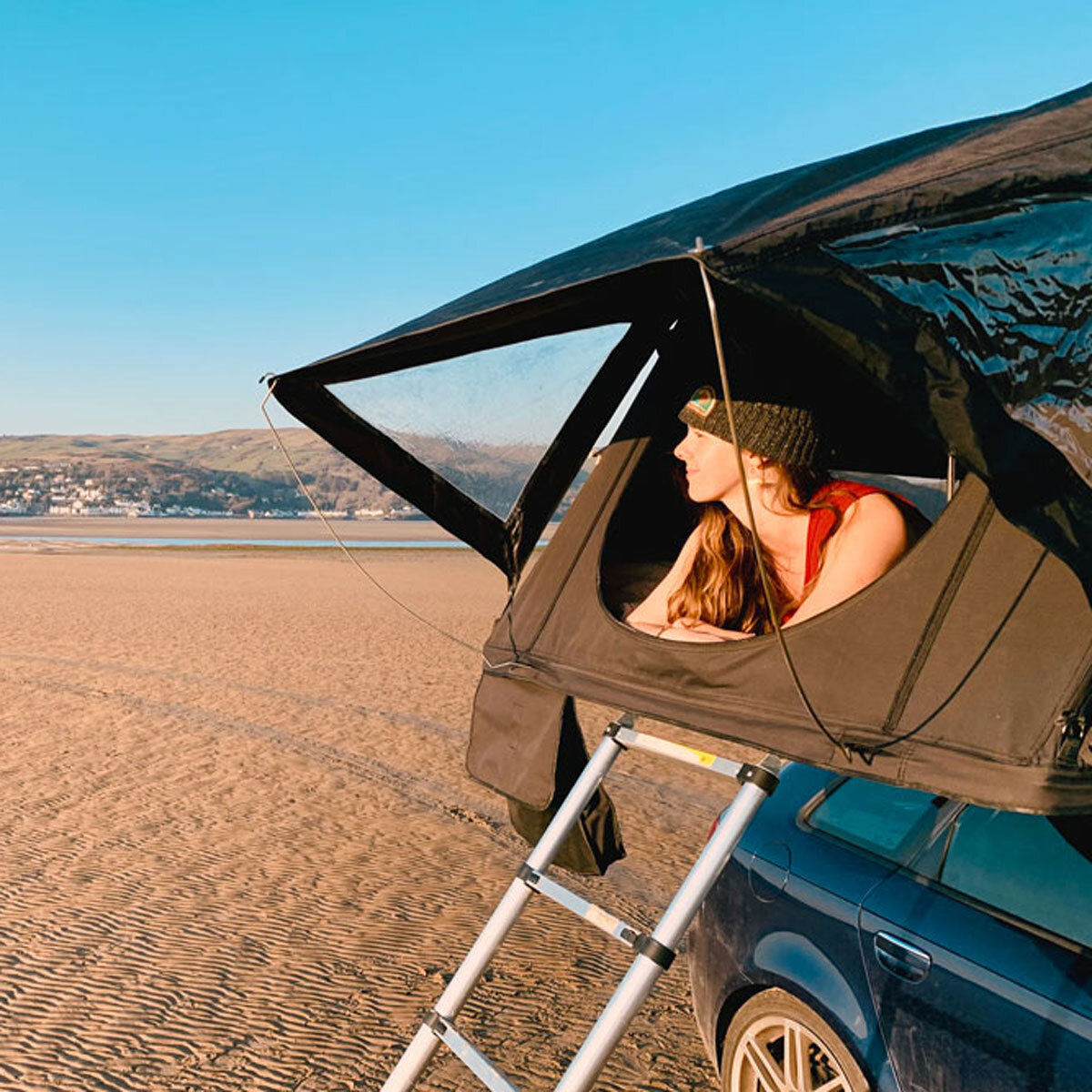 Lifestyle image of woman looking out from tentbox