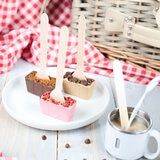 Hot chocolate spoons on plate and in mug with milk