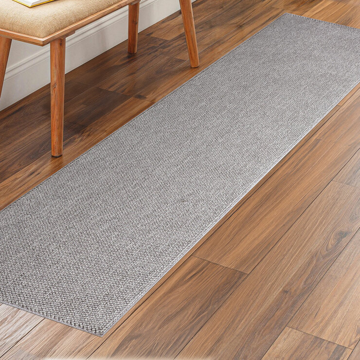 runner rug with a textured surface placed on a wooden floor