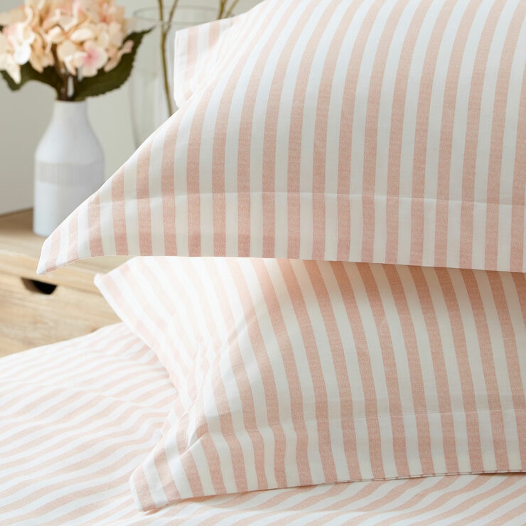 Pink and white vertically striped duvet set with matching pillowcases.