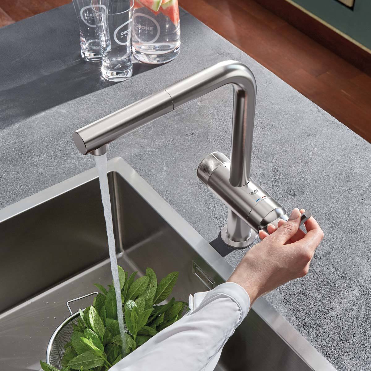 Lifestyle image of tap in use washing food in sink
