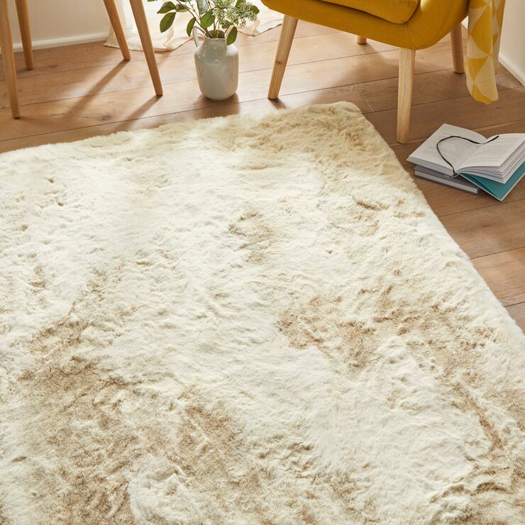 beige-coloured fluffy textured rug on wooden floor