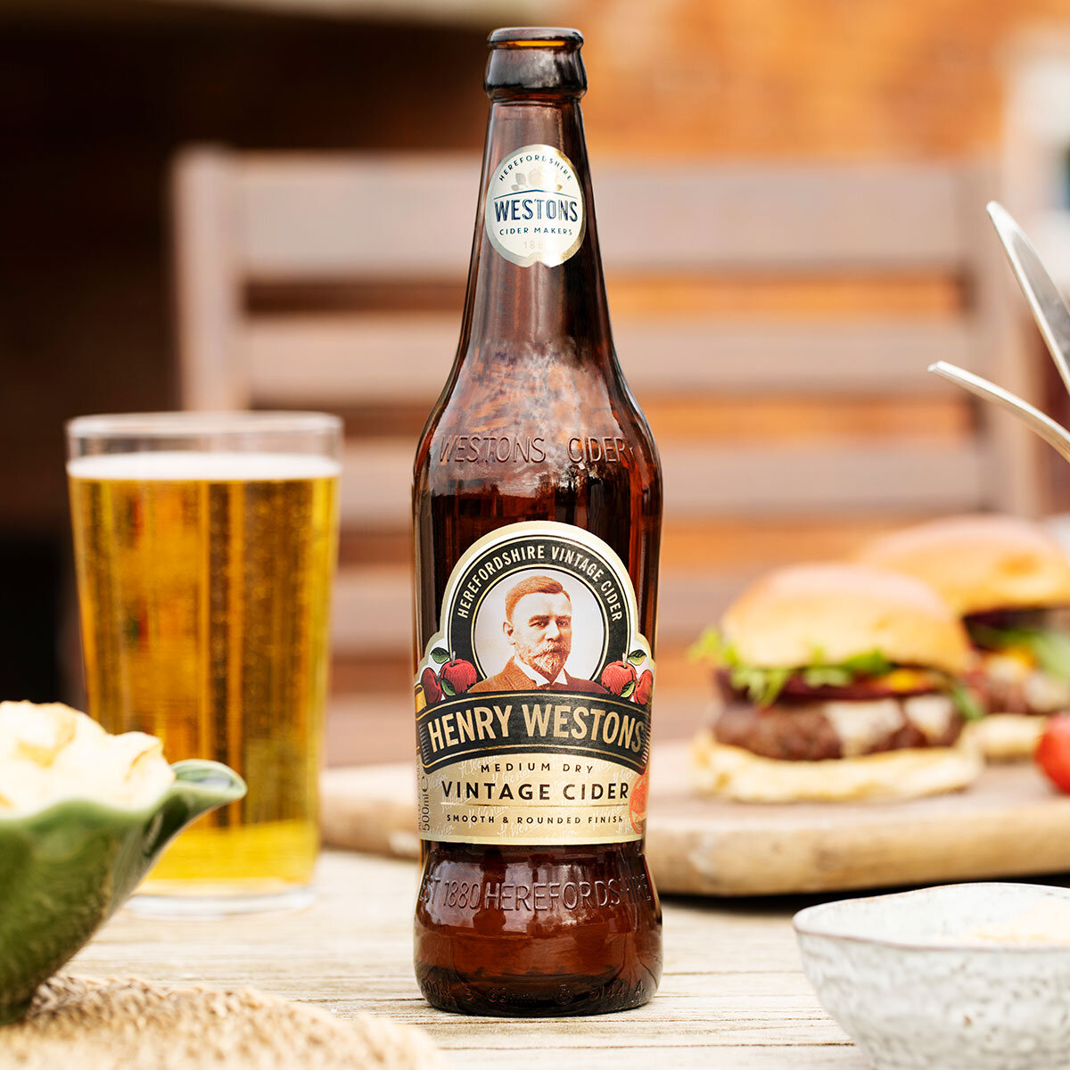Henry Westons Cider on table with burger