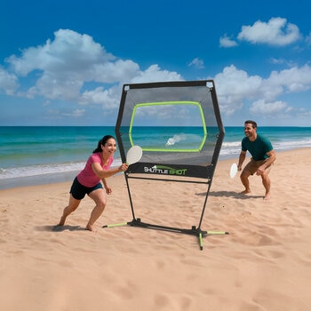 Lifestyle image showing two people playing Shuttle Shot on a beach