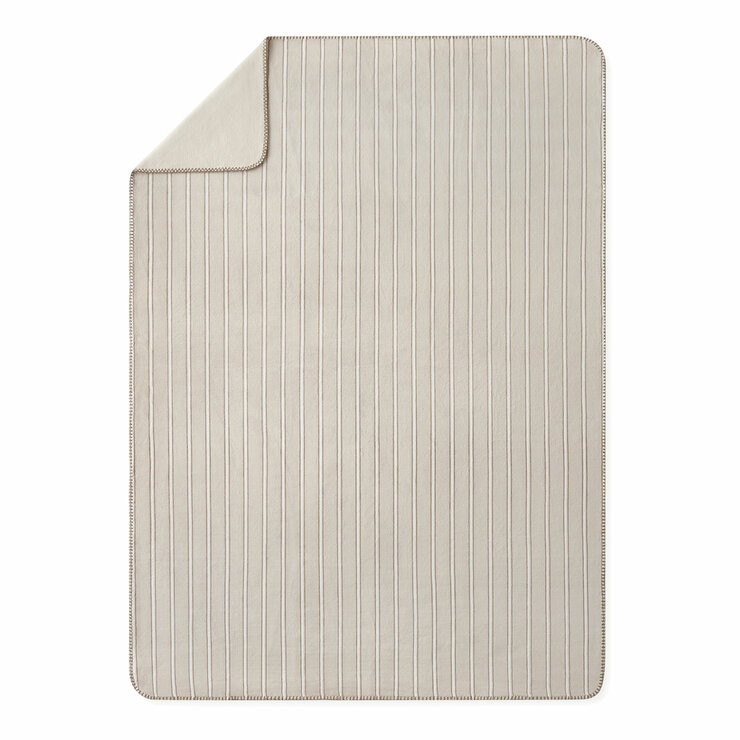 Taupe plaid throw, folded corner with a plain white background