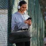 Lifestyle image of model holding the massager in a bag