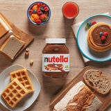 Nuttela Jar with Pancakes, Waffles and Fruit on a Table