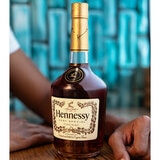 Lifestyle image of bottle with persons arms