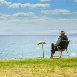 Lifestyle image of someone sat in a chair next to the spike table Lifestyle image of someone sat in a chair next to the spike table