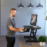 Lifestyle image of Seville Sit to Stand Pneumatic Desk Riser, standing