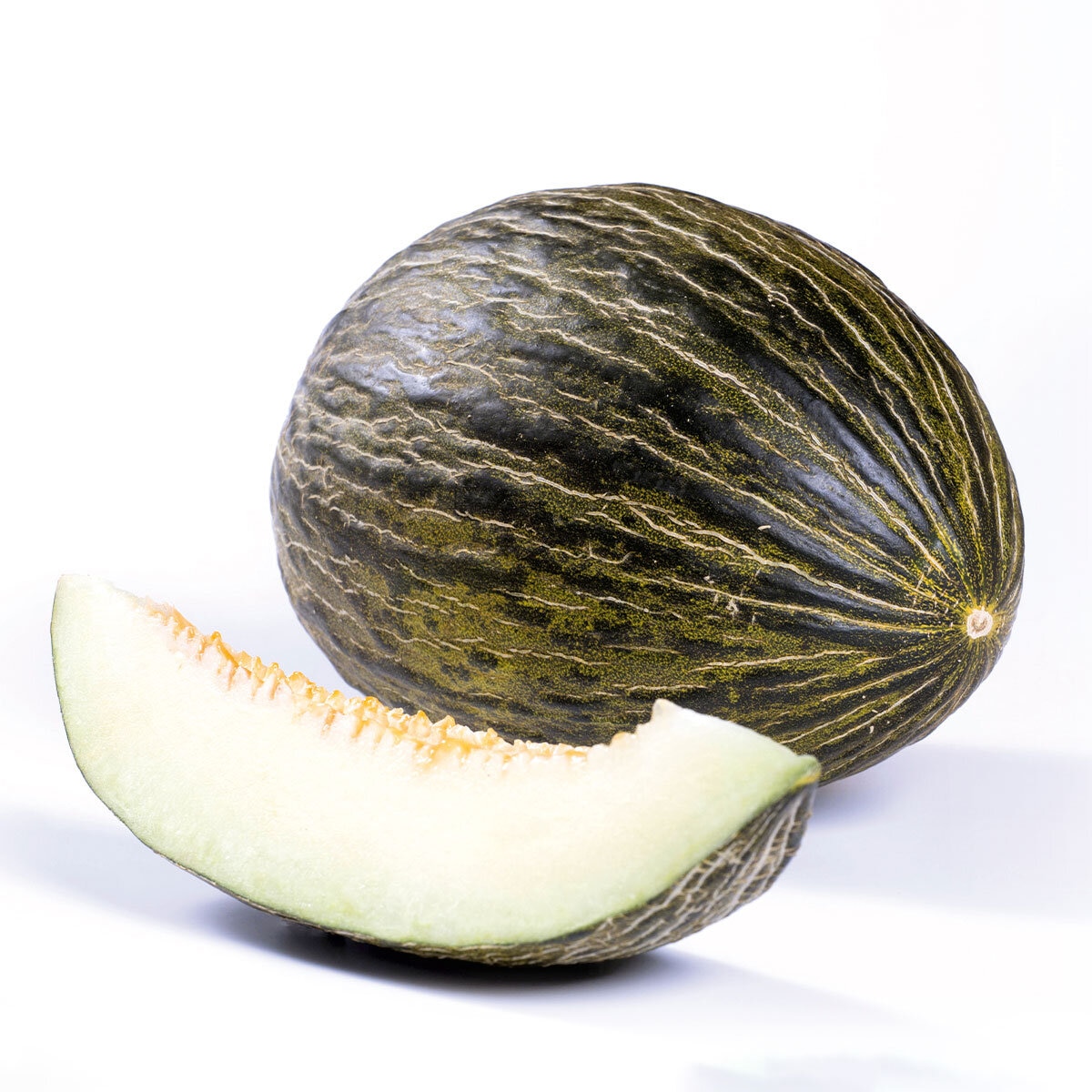 WHOLE MELON WITH A SLICE OF MELON IN FRONT OF IT