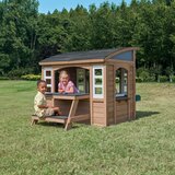 Lifestyle image of a child sat at the picnic area and another child in the playhouse Lifestyle image of a child sat at the picnic area and another child in the playhouse
