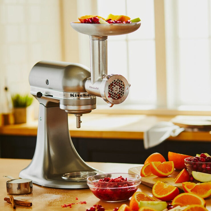 Lifestyle image of KitchenAid Metal Food Grinder attachment attached to the stand mixer