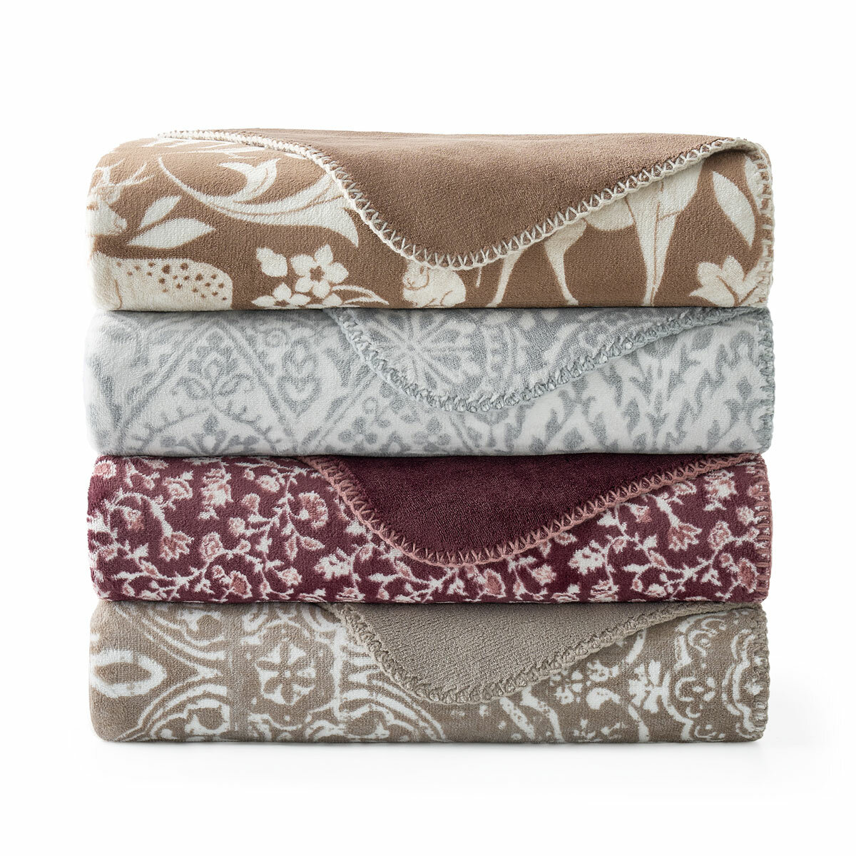 Black and white floral throw staged on white sofa in a lifestyle image Black and white floral throw staged on white sofa in a lifestyle image