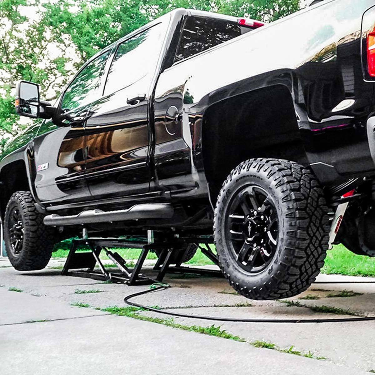 Image of QuickJack from the rear with Black pickup lifted