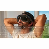 Lifestyle image of model using Renpho Artimis Blush Light Mask whilst sitting on sofa