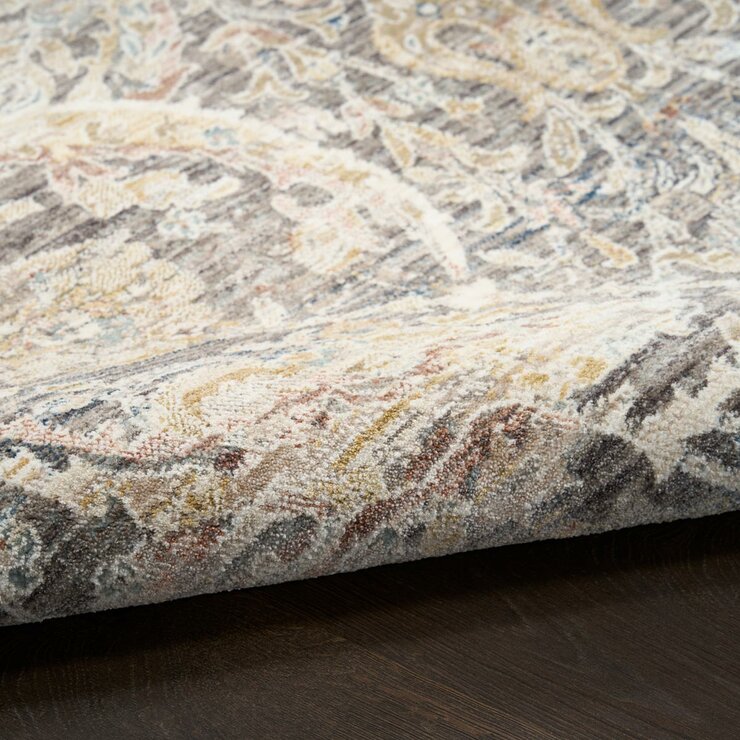 Grey and beige rug with detailed symmetrical pattern and vintage-style accents