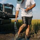 Lifestyle image showing someone washing their leg with the Rinsekit Pro Lifestyle image showing someone washing their leg with the Rinsekit Pro