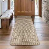 Runner rug with beige and brown geometric pattern on wooden floor in hallway