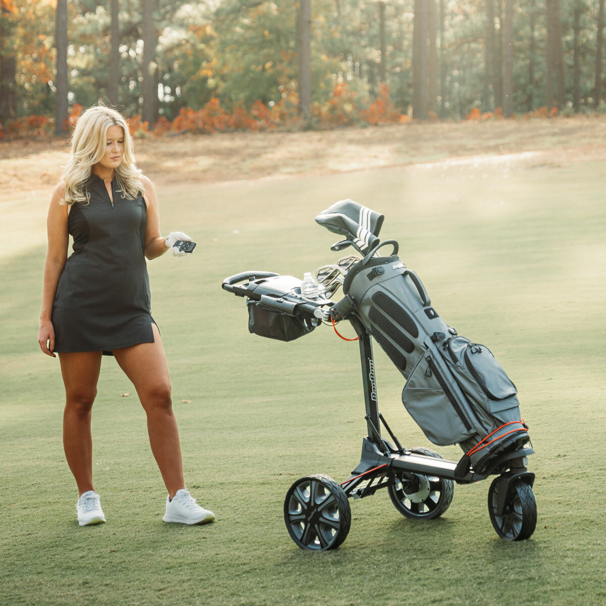 Lifestyle image of a woman with the Bag Boy Electric Golf Trolley