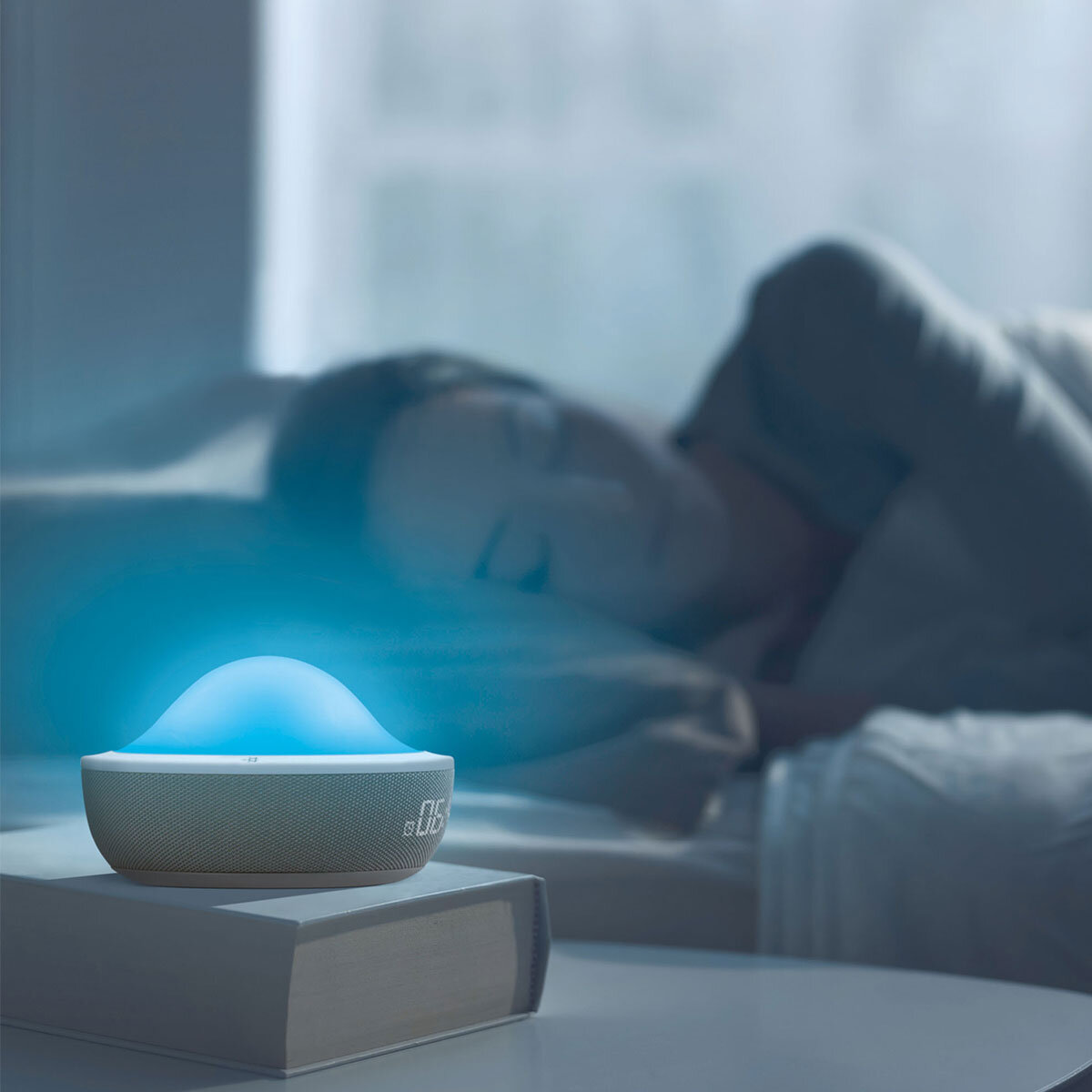 Lifestyle image of Aloha alarm clock glowing blue when person asleep