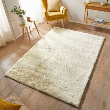 beige-coloured fluffy textured rug on wooden floor