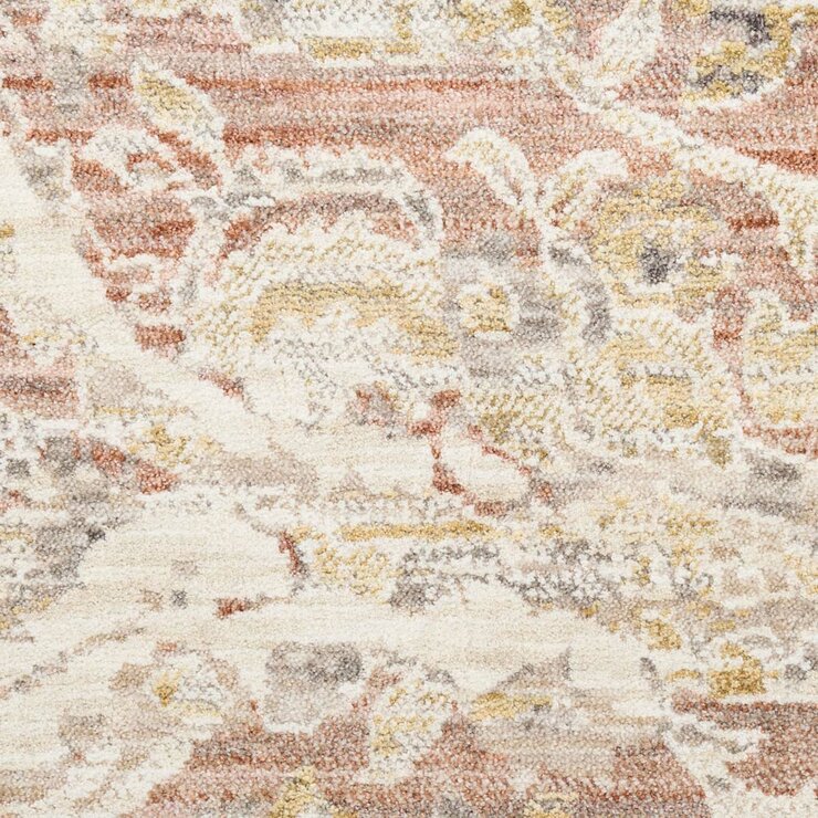 Pink and beige patterned rug with vintage-style floral and geometric motifs