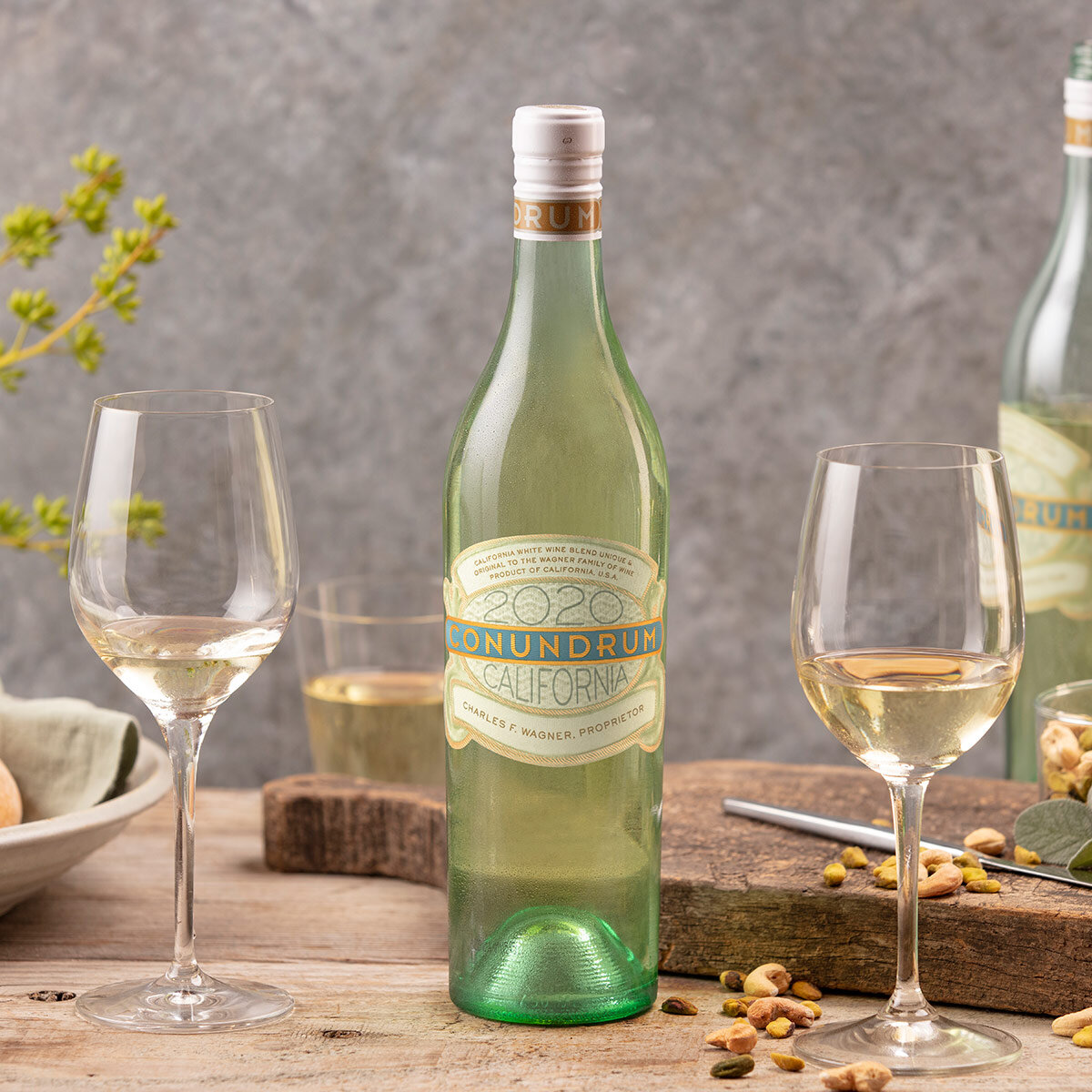Lifestyle image of Conundrum White Wine Blend, with Glasses