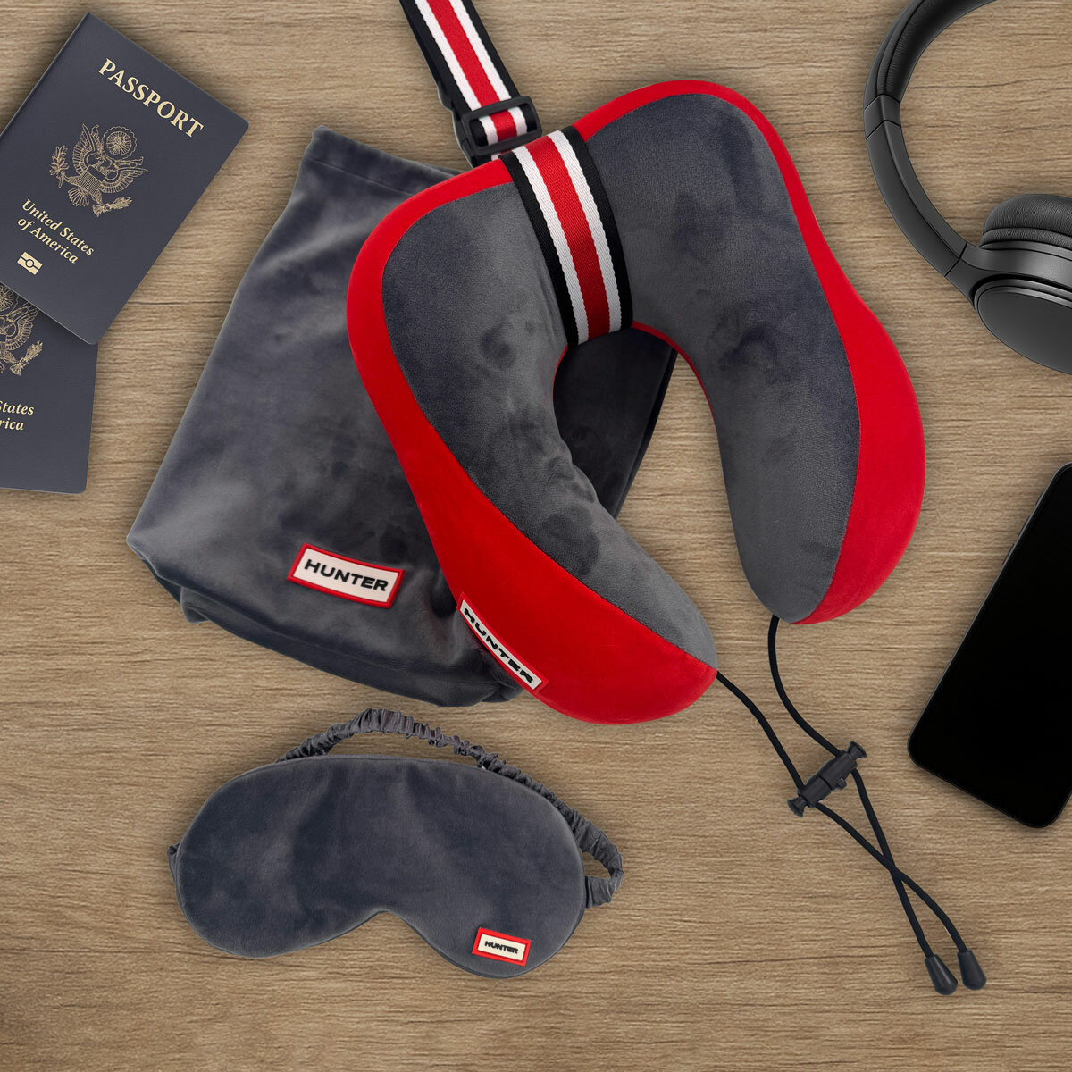 Grey and red travel pillow with striped accent and coordinating grey eye mask