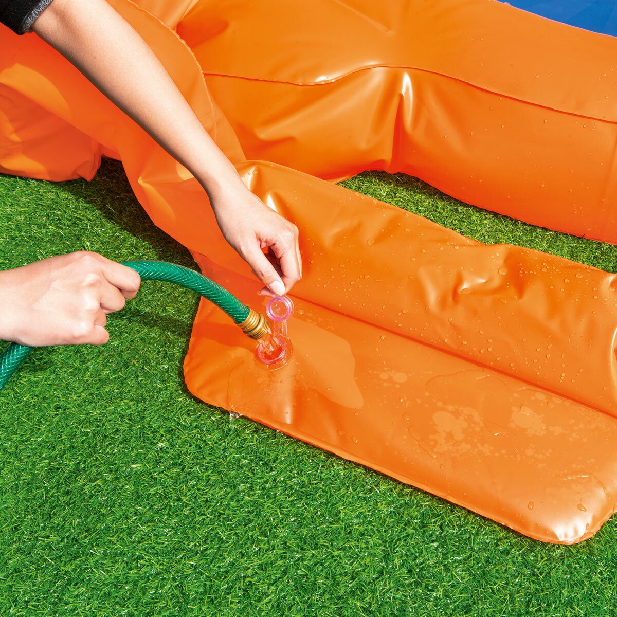 Lifestyle image of someone filling the base of the dartboard with water