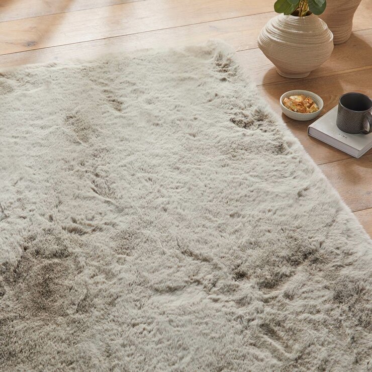 taupe-coloured fluffy textured rug on wooden floor taupe-coloured fluffy textured rug on wooden floor