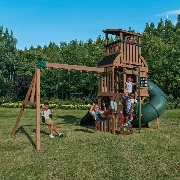 Lifestyle image of children playing on the KidKraft Summit Vista Playcentre and Swing Set