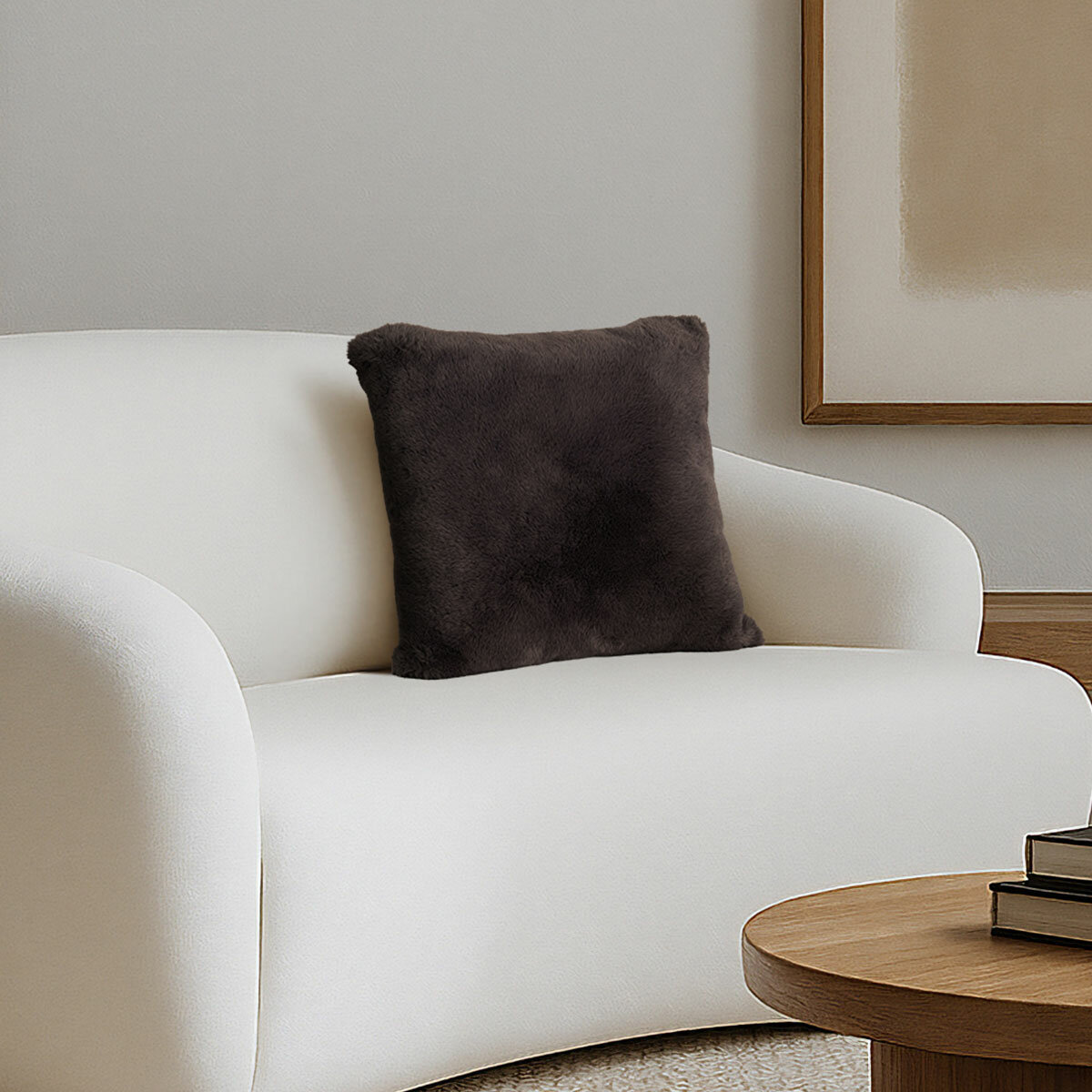 Super soft faux fur pillow in brown staged on sofa