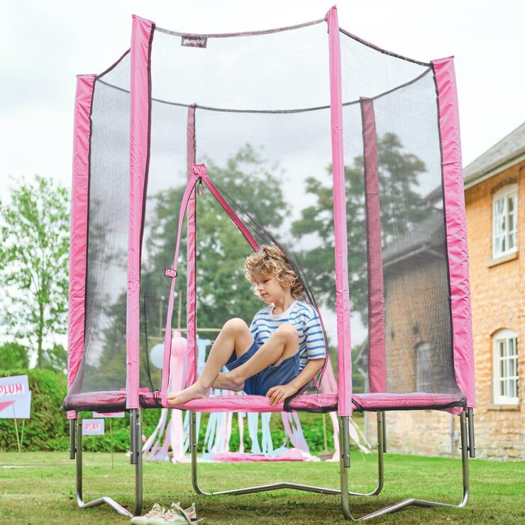 Lifestyle image of a child climbing out of the trampoline