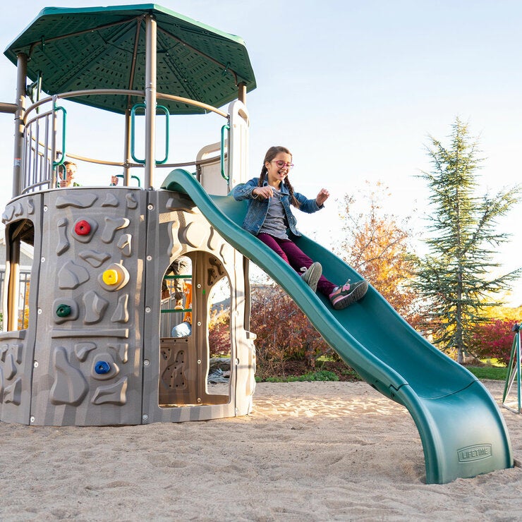 Lifestyle image of a child going down the slide Lifestyle image of a child going down the slide