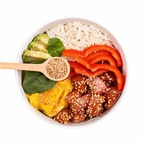 Lifestyle picture of sesame seeds over salad bowl