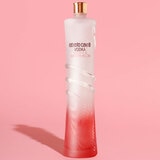 Lifestyle image of bottle in front of pink backgorund