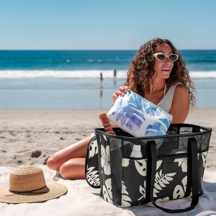 Lifestyle image of a woman putting an item into the bag Lifestyle image of a woman putting an item into the bag