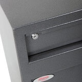 Close up image of corner of safe on white background