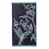 Dark blue towel with a light blue bird and branch illustration, teal borders, and “TED BAKER” branding