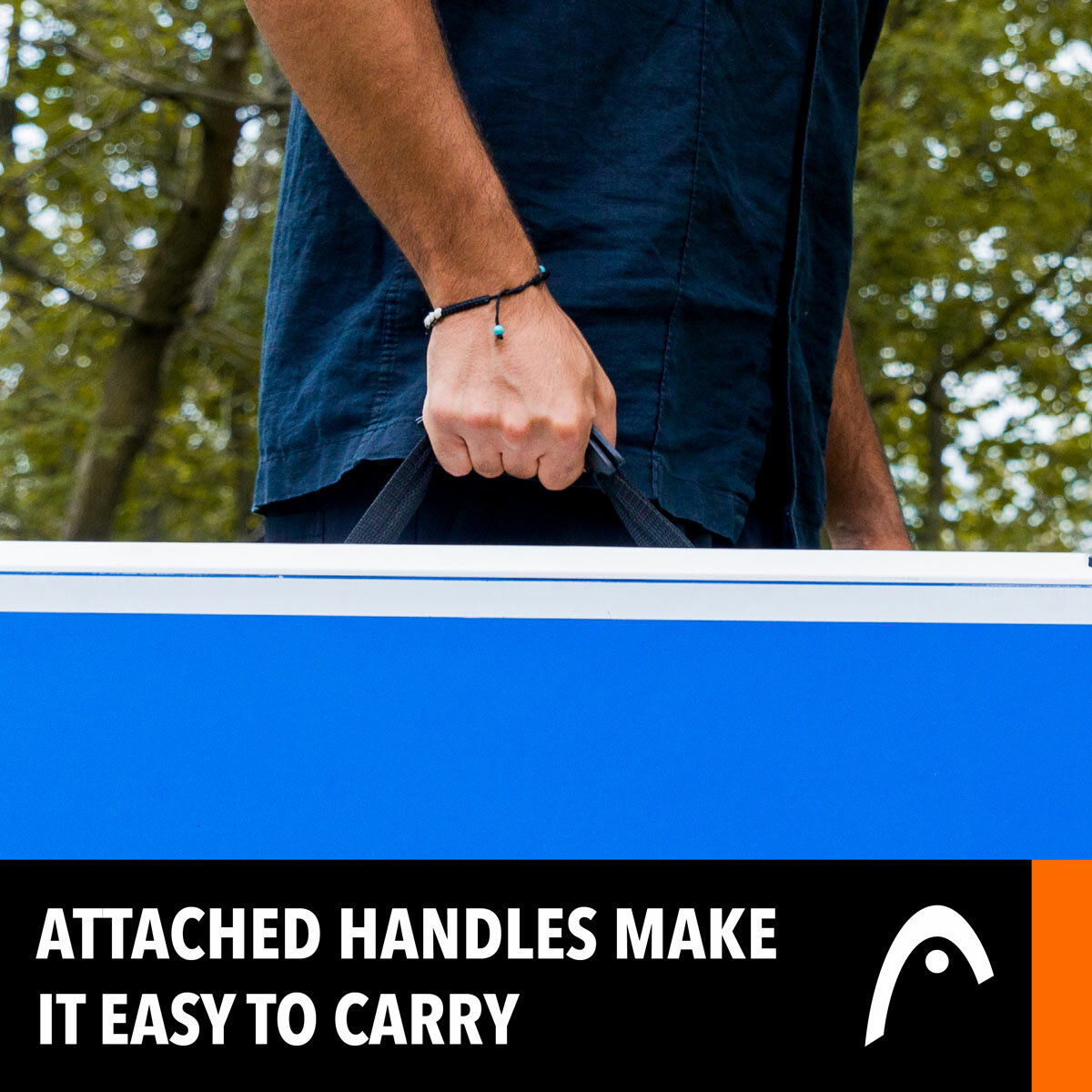Lifestyle image showing someone using the carry handle to transport the table Lifestyle image showing someone using the carry handle to transport the table