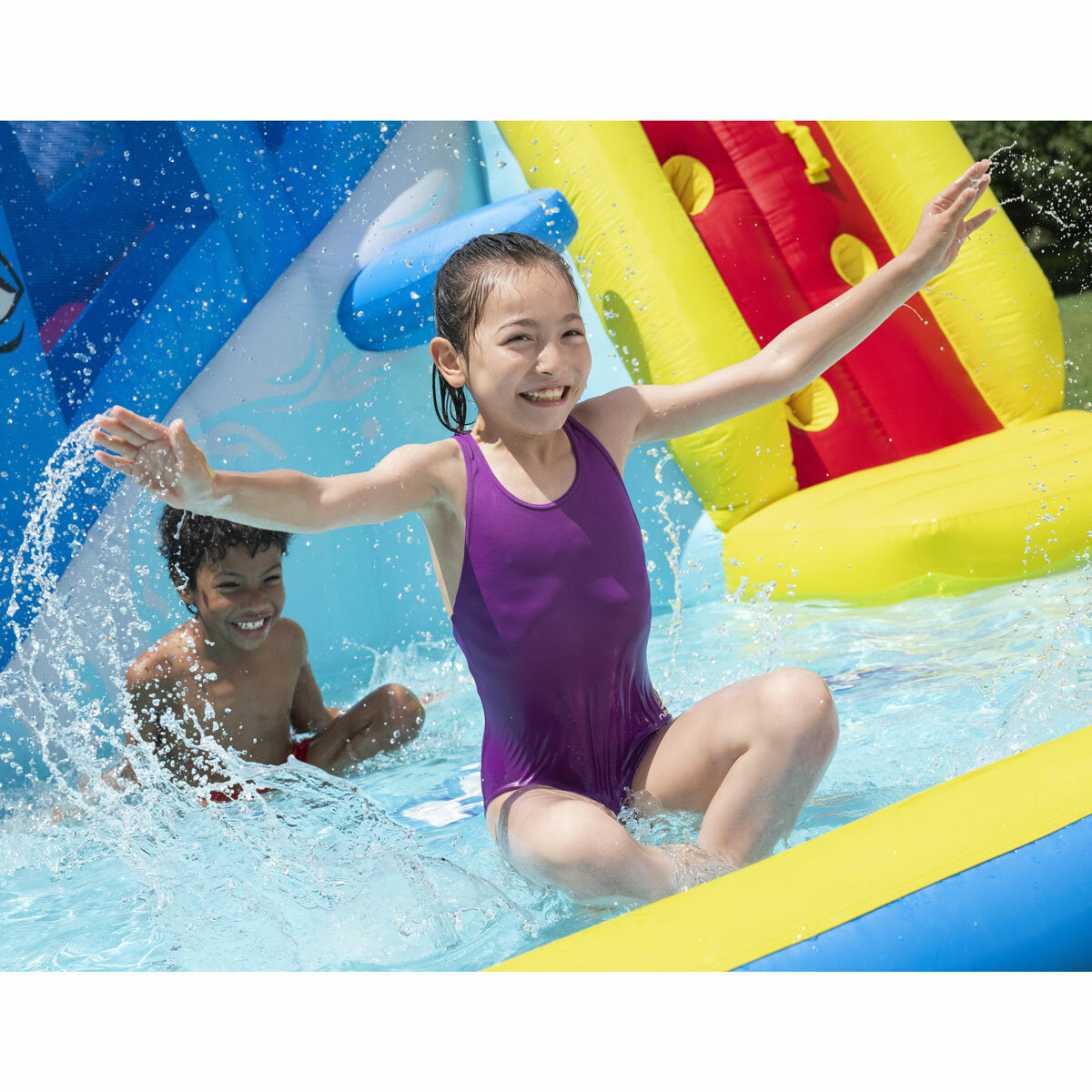 Lifestyle image of children playing in the splash pool