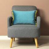 Lifestyle Image of Carnival Velvet Bolster Cushion on Accent Chair