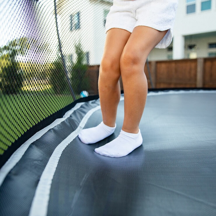 A lifestyle image a child jumping on the Springfree trampoline