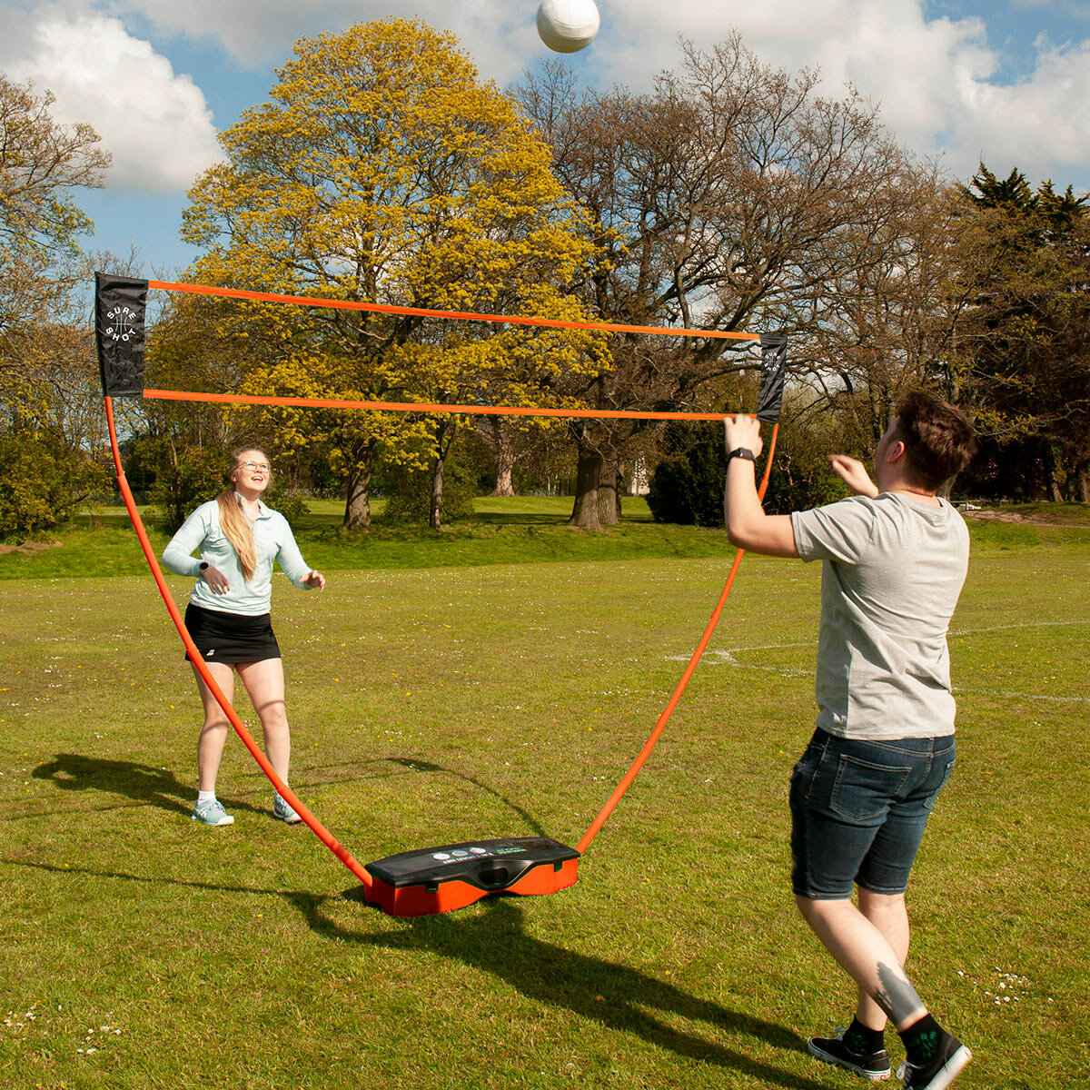 Lifestyle image of two people playing volleyball