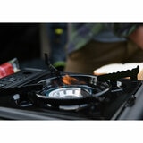 Lifestyle image of the stove with a lit flame