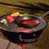 Lifestyle image of wok on BBQ