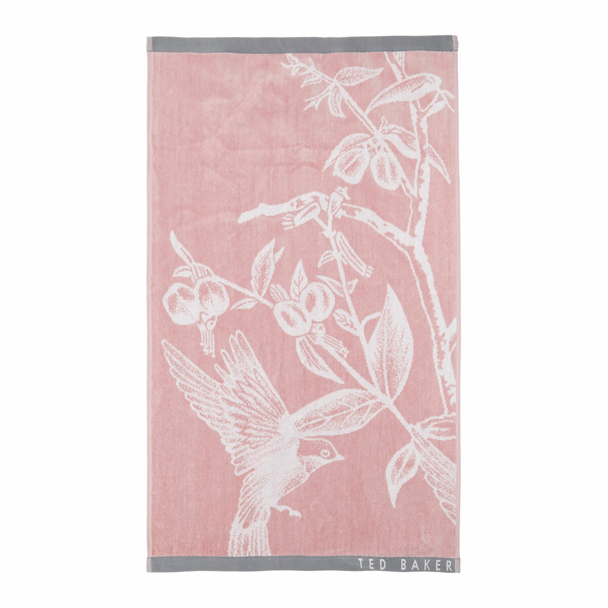 Pink towel with a white bird and branch design, grey borders, and “TED BAKER” branding in the corner
