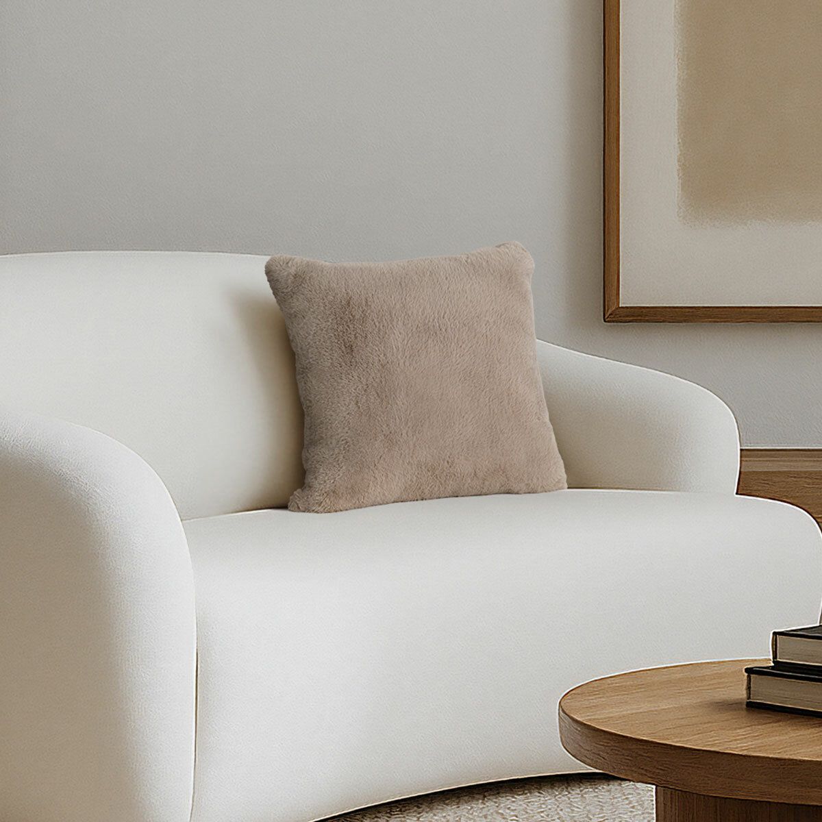 Super soft faux fur pillow in taupe staged on sofa