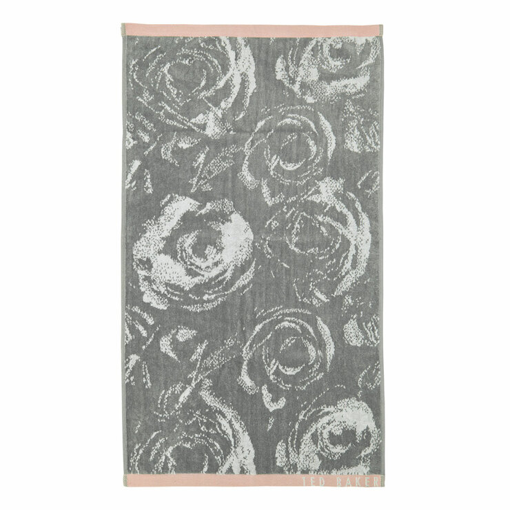 Grey towel with white rose pattern, light pink borders, and “TED BAKER” branding in the corner